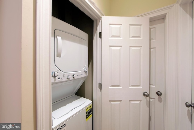 laundry room with stacked washer / dryer and laundry area