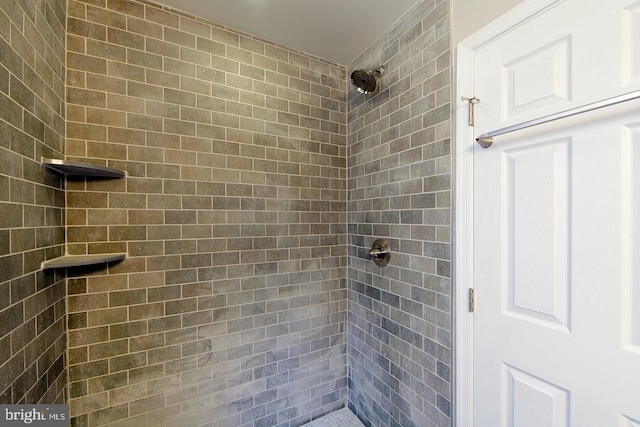 bathroom with tiled shower