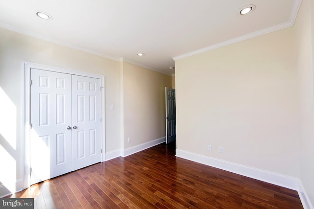 unfurnished bedroom featuring baseboards, ornamental molding, recessed lighting, hardwood / wood-style flooring, and a closet