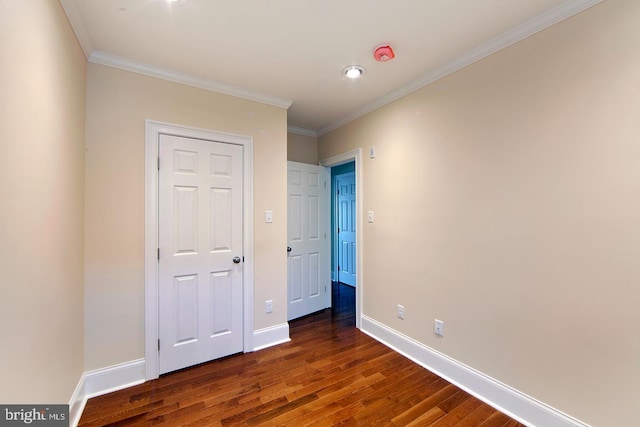 unfurnished bedroom with crown molding, wood finished floors, and baseboards