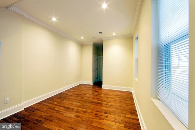 unfurnished room featuring visible vents, ornamental molding, wood finished floors, recessed lighting, and baseboards