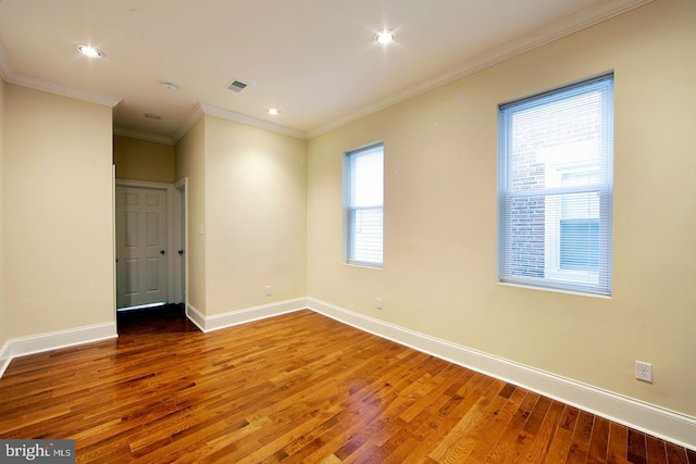 unfurnished room featuring crown molding, recessed lighting, wood finished floors, and baseboards