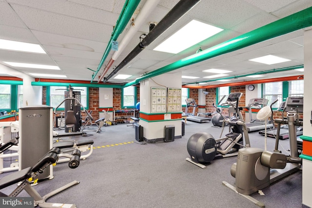 gym with a paneled ceiling