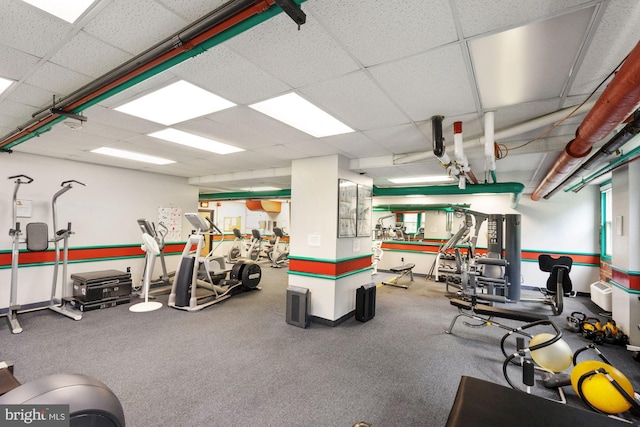 workout area featuring a paneled ceiling