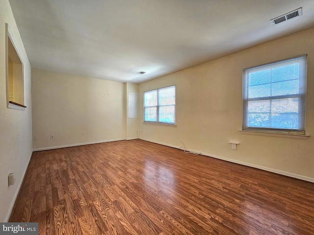 empty room with hardwood / wood-style flooring