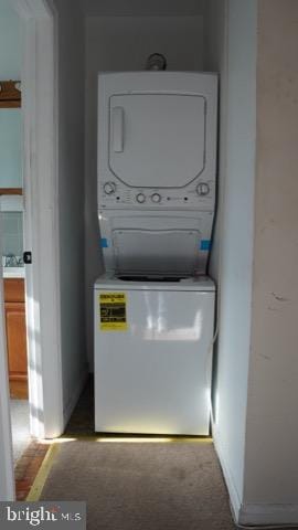 laundry room with stacked washer and dryer