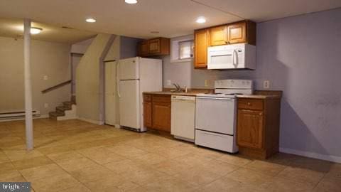 kitchen featuring white appliances and a baseboard radiator