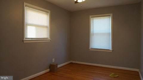 spare room featuring ceiling fan and wood-type flooring