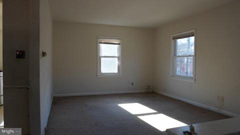 empty room featuring a healthy amount of sunlight and carpet floors