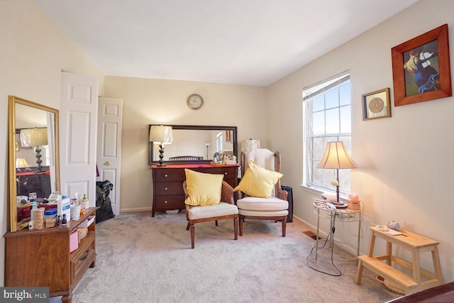 sitting room featuring light colored carpet