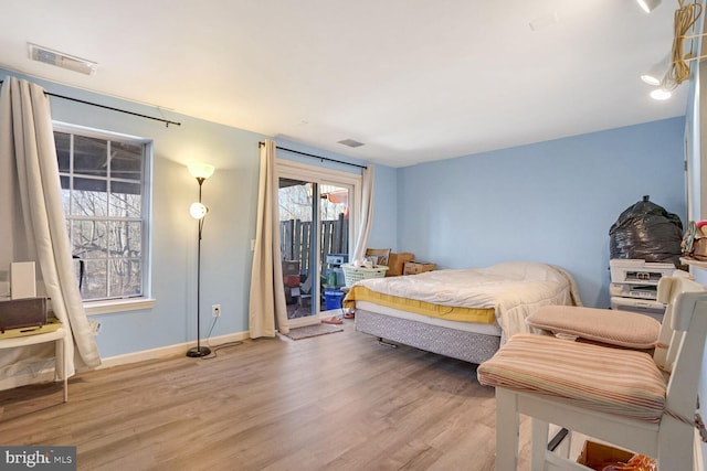 bedroom with light hardwood / wood-style flooring and access to outside