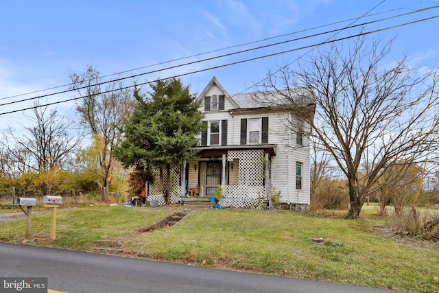 view of front of property with a front yard and covered porch