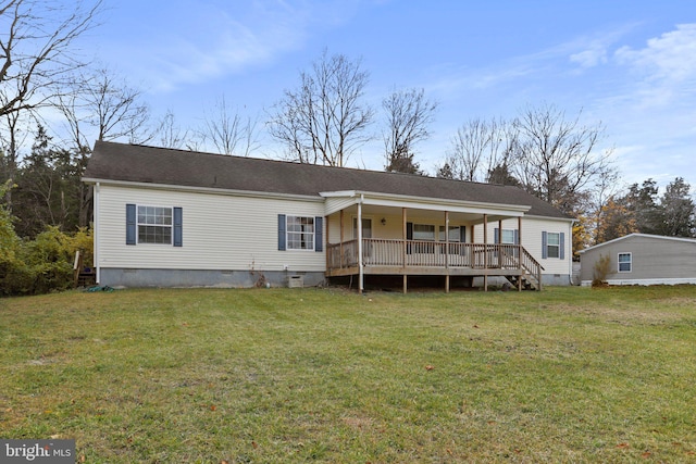 back of house featuring covered porch and a lawn