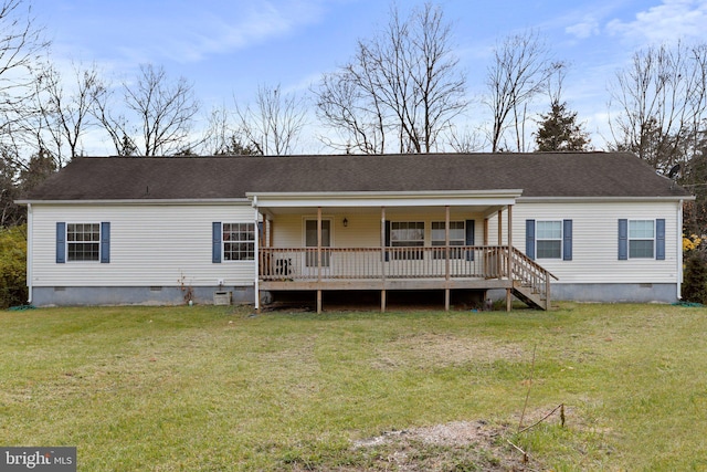 rear view of property with a yard and a deck