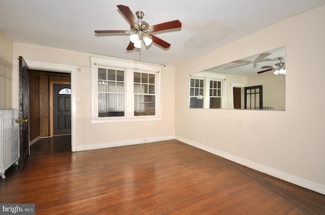 unfurnished room with dark hardwood / wood-style floors and ceiling fan