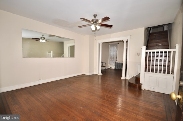 empty room featuring radiator, dark wood-type flooring, and ceiling fan