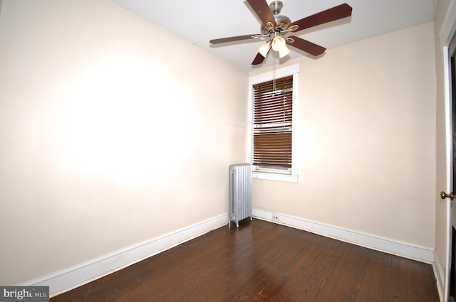 unfurnished room with dark hardwood / wood-style flooring, radiator, and ceiling fan