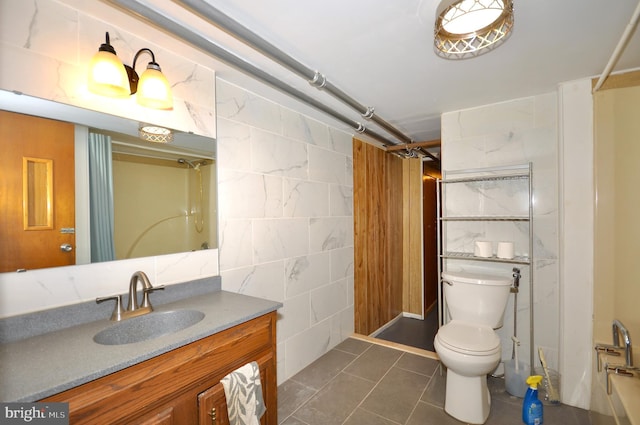 full bathroom with tile patterned floors, toilet,  shower combination, tile walls, and vanity