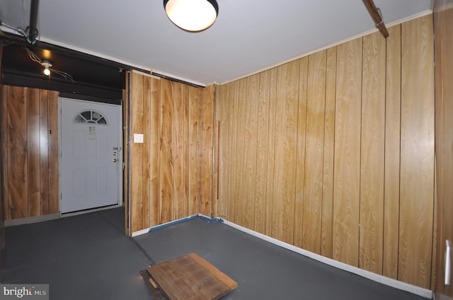 spare room featuring a barn door and wood walls