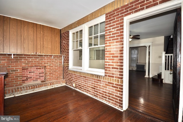 interior space with ceiling fan and radiator