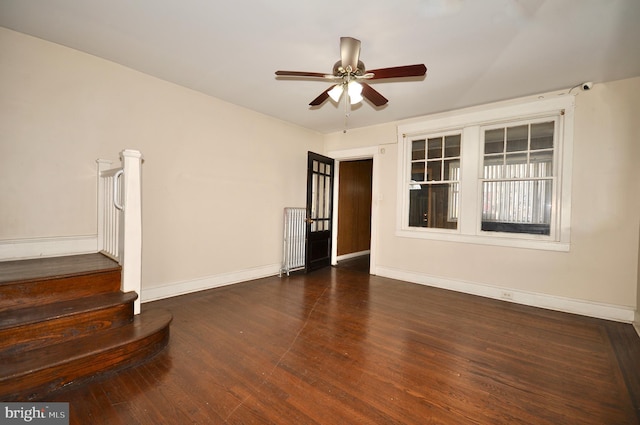 unfurnished room featuring ceiling fan and dark hardwood / wood-style flooring