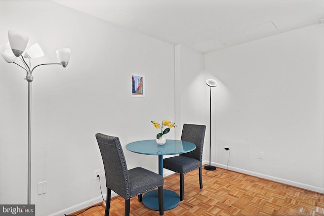 dining space featuring light parquet floors