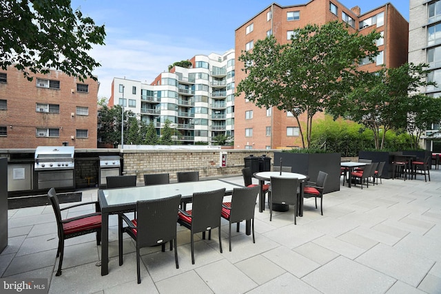 view of patio featuring area for grilling and a grill