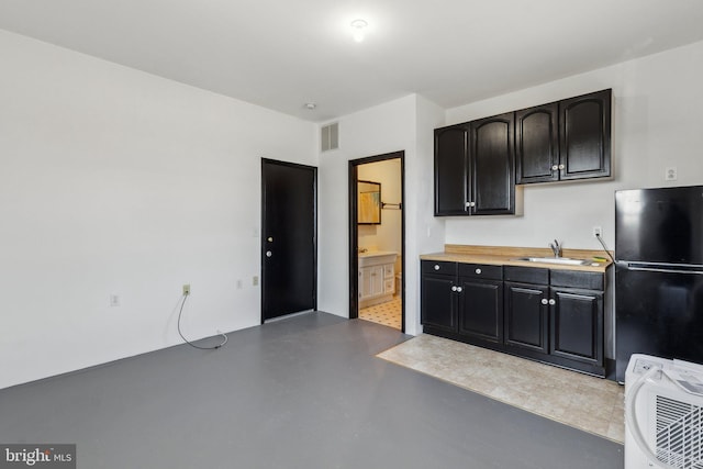 kitchen with sink and stainless steel fridge