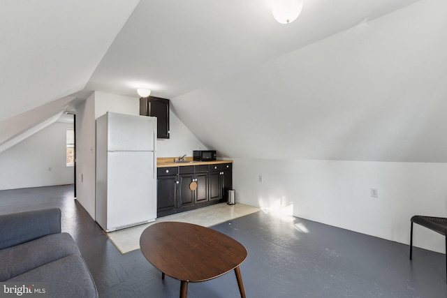 additional living space featuring vaulted ceiling and sink