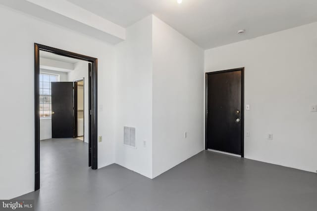 unfurnished room with concrete floors