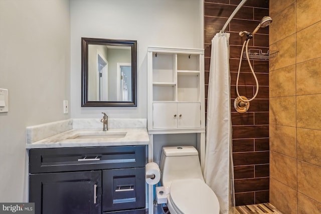 bathroom featuring vanity, toilet, and walk in shower