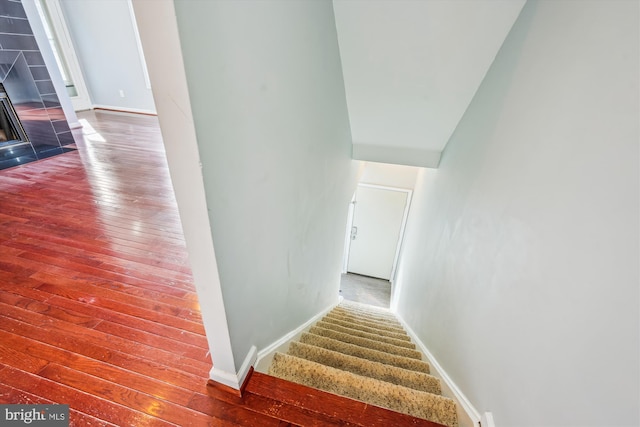 stairway with hardwood / wood-style flooring