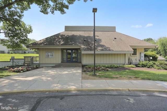 view of front of property with a front lawn and french doors