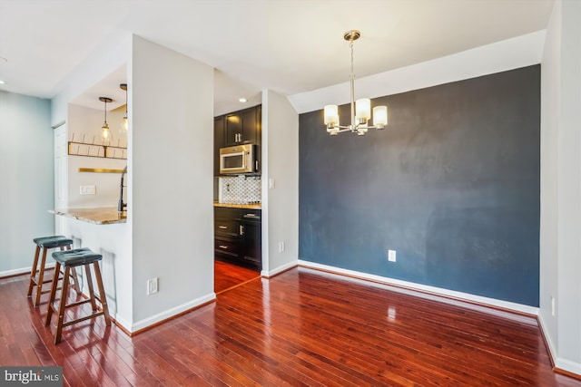 dining room featuring dark hardwood / wood-style flooring and a chandelier