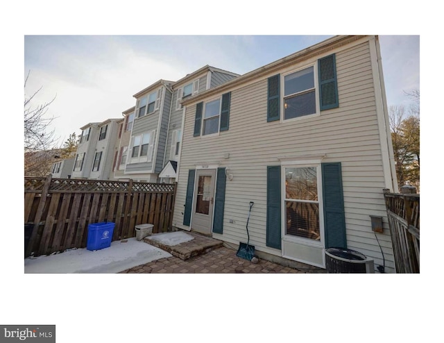 rear view of property featuring central air condition unit