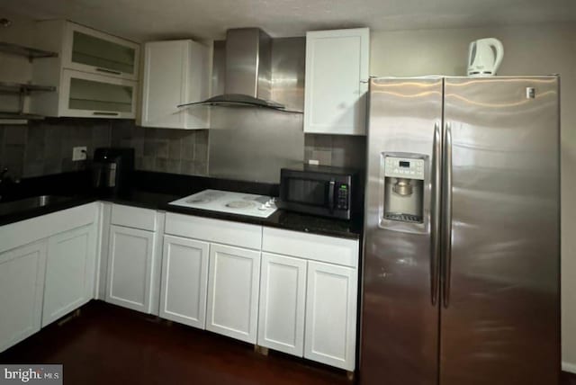 kitchen with wall chimney exhaust hood, sink, white cabinets, stainless steel appliances, and backsplash