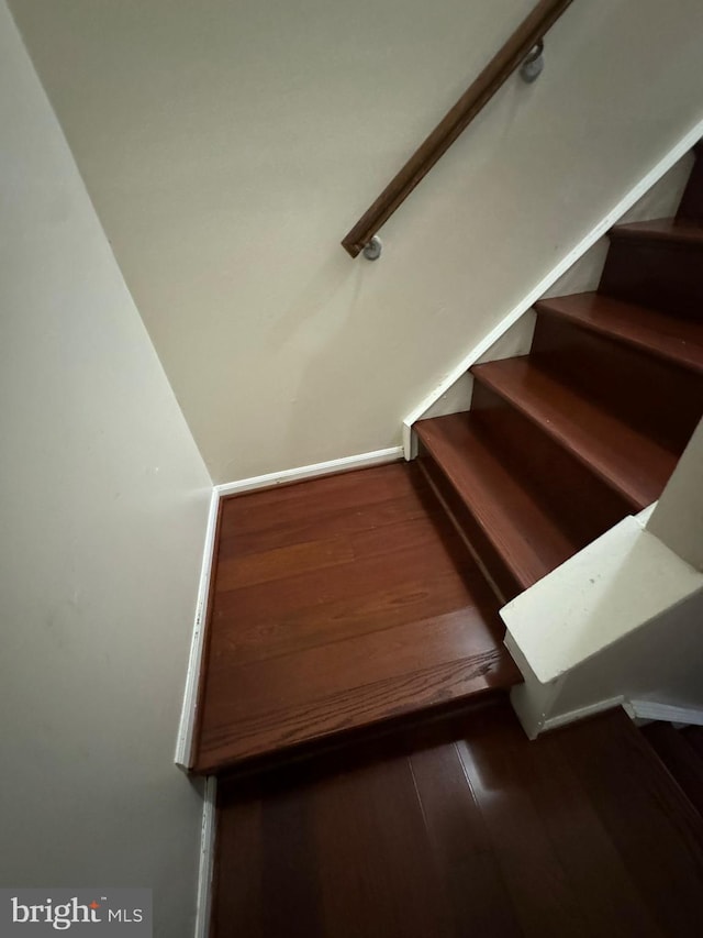 staircase featuring hardwood / wood-style floors