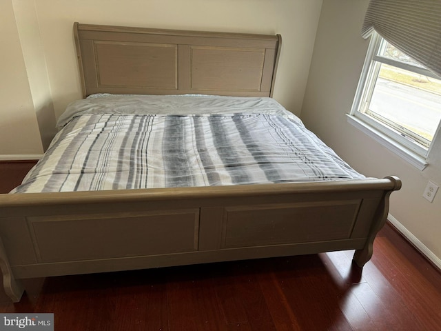 bedroom with dark wood-type flooring