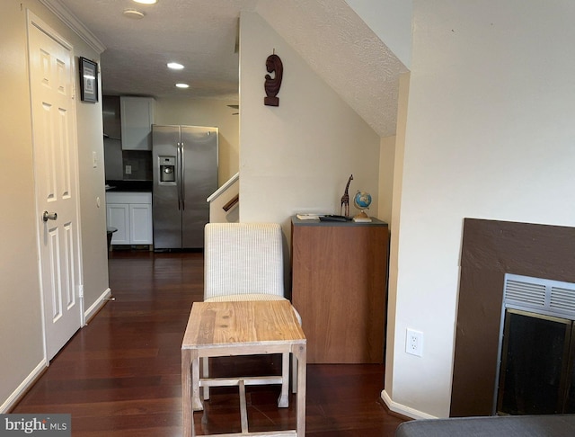 hall with dark hardwood / wood-style floors and a textured ceiling