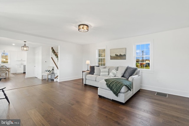 living room featuring dark wood-type flooring