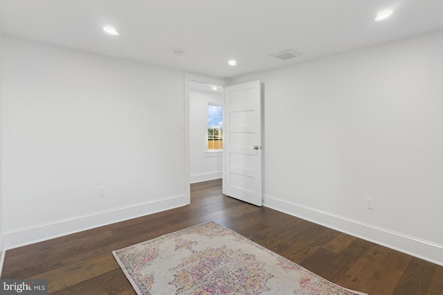 spare room featuring dark hardwood / wood-style floors