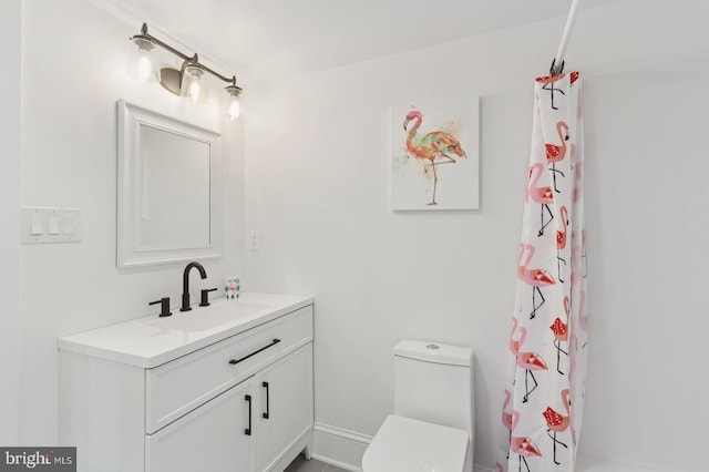 bathroom featuring vanity, toilet, and a shower with shower curtain