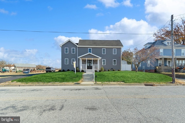 view of front facade with a porch and a front lawn