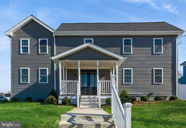 view of front of property featuring a front lawn, covered porch, and french doors