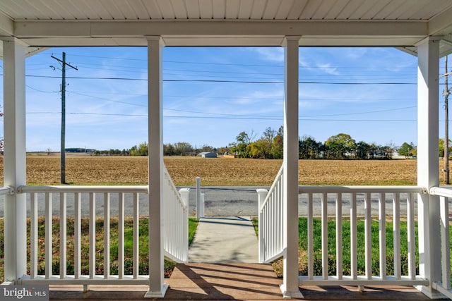 sunroom featuring a healthy amount of sunlight and a rural view