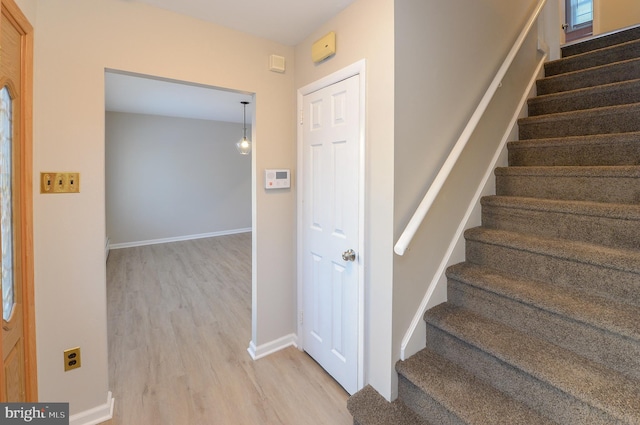 stairway featuring hardwood / wood-style flooring