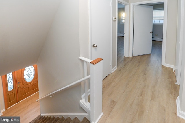 interior space featuring a baseboard radiator and light hardwood / wood-style floors