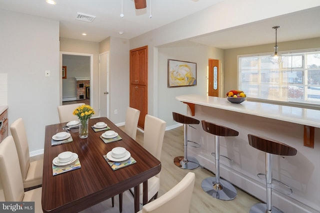 dining area featuring light hardwood / wood-style floors and ceiling fan