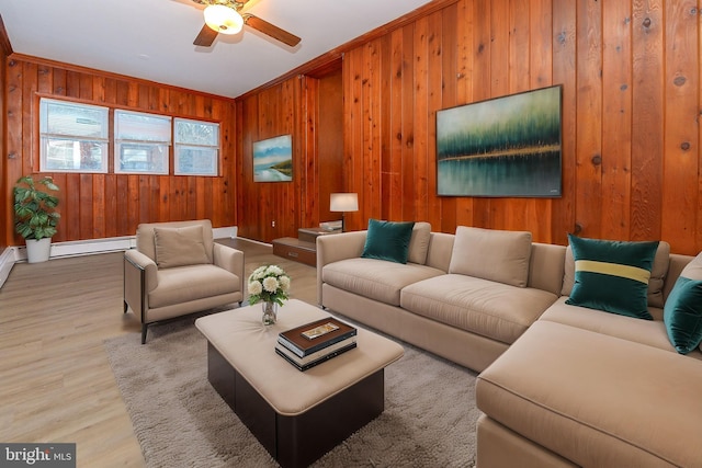 living room with crown molding, hardwood / wood-style floors, ceiling fan, and wooden walls