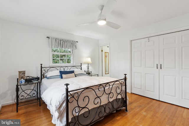 bedroom featuring light hardwood / wood-style floors, a closet, and ceiling fan